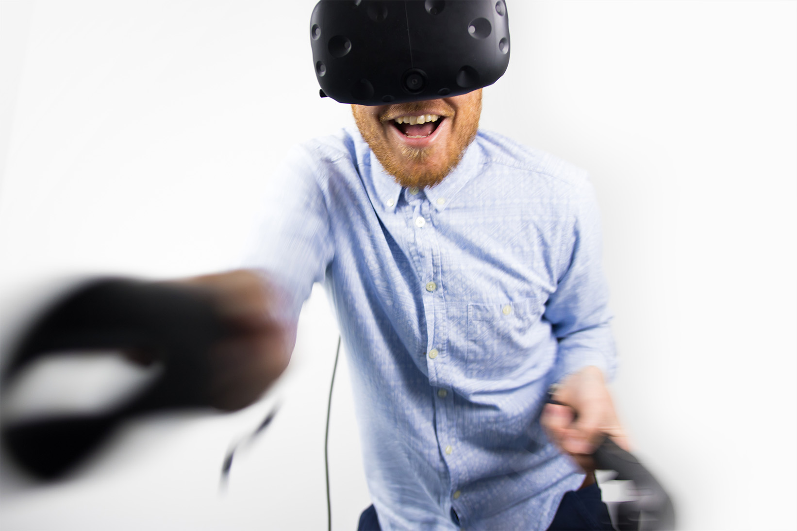 A person wearing a VR headset lunges towards the camera