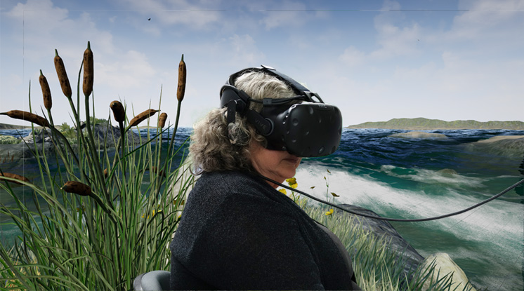 A woman sits in a VR headset with a digital environment behind her